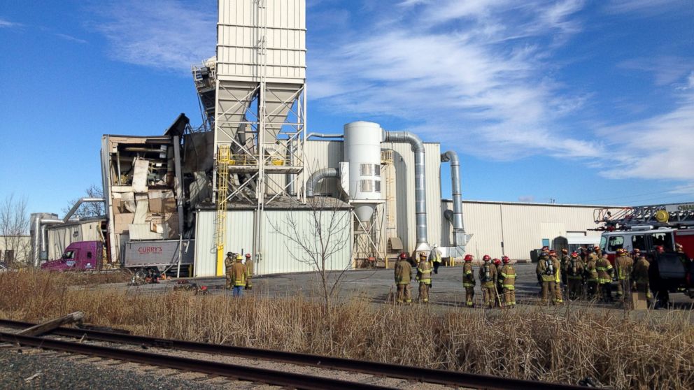 PHOTO: Firefighters stand outside the International Nutrition plant in Omaha, Neb. where a fire and explosion took place Jan. 20, 2014.