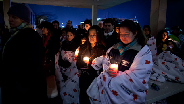 PHOTO: Residents hold a candlelight vigil outside Newtown High School after President Barack Obama delivered remarks at an interfaith vigil for the victims of the Sandy Hook Elementary School shooting on Dec. 16, 2012, at Newtown High School in Newtown, C