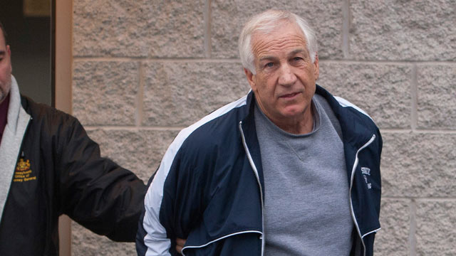 PHOTO: Former Penn State assistant football coach Jerry Sandusky, right, leaves the office of Centre County District Justice Daniel A. Hoffman under escort by Pennsylvania State Police and Attorney General's Office officials, Bellefonte, Pa., Dec. 7, 2011