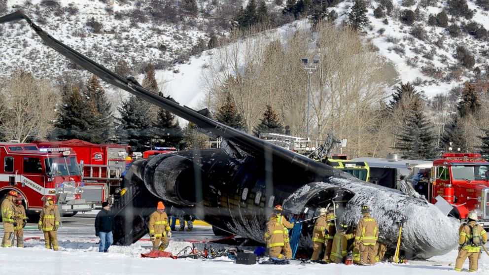 PHOTO: Emergency crews work near a passenger plane that crashed upon landing at the Aspen-Pitkin County Airport in Aspen, Colo., Sunday, Jan. 5, 2014.