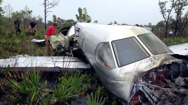PHOTO: Emergency personnel investigate the site where a Pilatus PC-12, a single-engine turboprop passenger plane, crashed near Lake Weohyakapka, aka Lake Walk In the Water, in southeast Polk County, Fla., June 7, 2012.