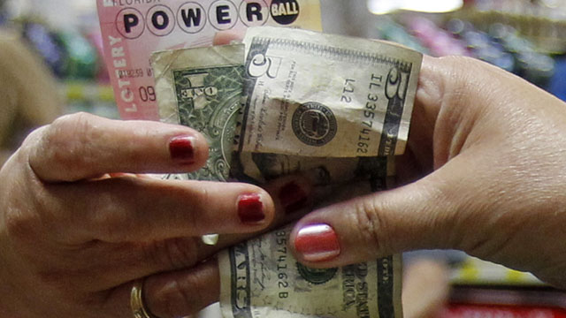 PHOTO: A customer buys three Powerball tickets at a local supermarket in Hialeah, Fla.,Tuesday, Nov. 27, 2012.