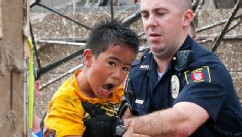 PHOTO: A boy is pulled from beneath a collapsed wall at the Plaza Towers Elementary School following a tornado in Moore, Okla., May 20, 2013.