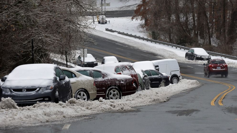 PHOTO: Abandoned vehicles line a roadside following a snow and ice storm in Chapel Hill, N.C., Feb. 13, 2014.