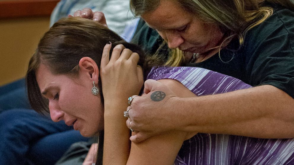 PHOTO: Courtney Turnipseed, a close friend of Spc. Tevin Geike, and her mother, Kimberly Turnipseed, react as Commissioner Meagan Foley releases Pfc. Cedarium Johnson, 21, without bail to the supervision of Joint Base Lewis-McChord, Tuesday, Oct. 8, 2013.