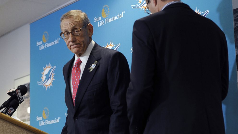 PHOTO: Miami Dolphins owner Stephen Ross, left, and CEO Tom Garfinkel cross paths as they address the media before an NFL football game against the Tampa Bay Buccaneers, Nov. 11, 2013, in Tampa, Fla.
