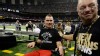Former New Orleans Saints player Steve Gleason, who is suffering from ALS, is ushered onto the field before an NFL football game against the Philadelphia Eagles at the Mercedes-Benz Superdome in New Orleans, Nov. 5, 2012.