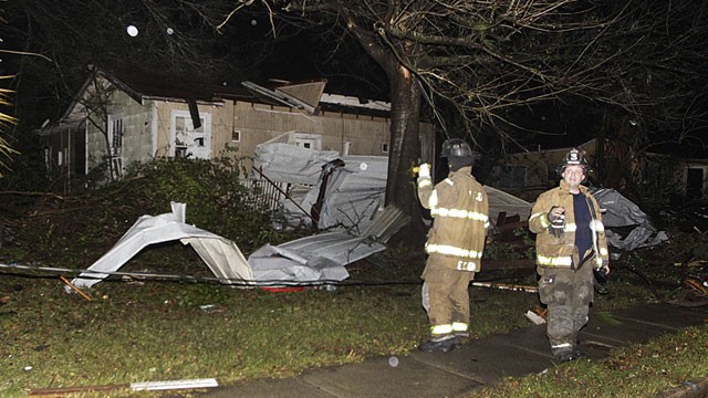 PHOTO: Firefighters go door-to-door on North Carlen Street in the Midtown section of Mobile, Ala. after a tornado touched down Tuesday, Dec. 25, 2012.