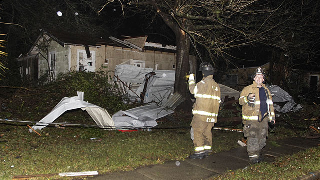 PHOTO: Firefighters go door-to-door on North Carlen Street in the Midtown section of Mobile, Ala. after a tornado touched down Tuesday, Dec. 25, 2012.