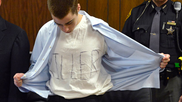 PHOTO: T.J. Lane unbuttons his shirt during sentencing, March 19, 2013, in Chardon, Ohio. Lane, was given three lifetime prison sentences without the possibility of parole for opening fire last year in a high school cafeteria in a rampage that left three