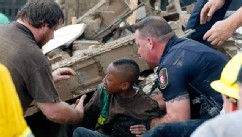 PHOTO: A boy is pulled from beneath a collapsed wall at the Plaza Towers Elementary School following a tornado in Moore, Okla., May 20, 2013.