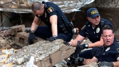 PHOTO: Moore police dig through the rubble of the Plaza Towers Elementary School following a tornado in Moore, Okla., May 20, 2013.
