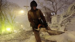 PHOTO: Louie Rodriguez of the New Bedford Forestry Department cuts a fallen tree at the intersection of Rotch St. and Maple St. in New Bedford, Mass., on Friday, Feb. 8, 2013, after heavy snow and winds from a storm.