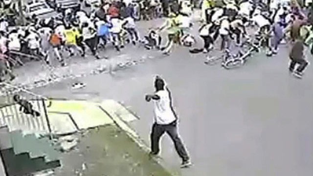 PHOTO: In this image taken from video and provided on May 13, 2013, a possible shooting suspect in a white shirt, bottom center, shoots into a crowd of people, on May 12, 2013 in New Orleans.