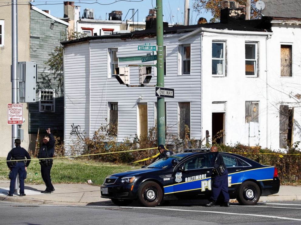 PHOTO: Members of the Baltimore Police Department gather near the scene of the shooting death of Baltimore Police detective Sean Suiter in Baltimore, Nov. 17, 2017.
