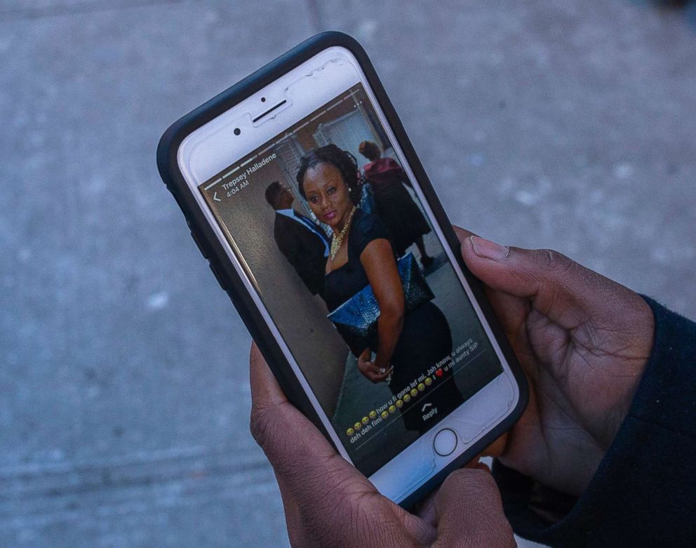 PHOTO: Sasha Answer, resident of an apartment building where a deadly fire took place, talks to a friend as he displays a picture published on social media of Karen Stewart-Francis, who died in the fire, in the Bronx borough of New York, Dec. 29, 2017.