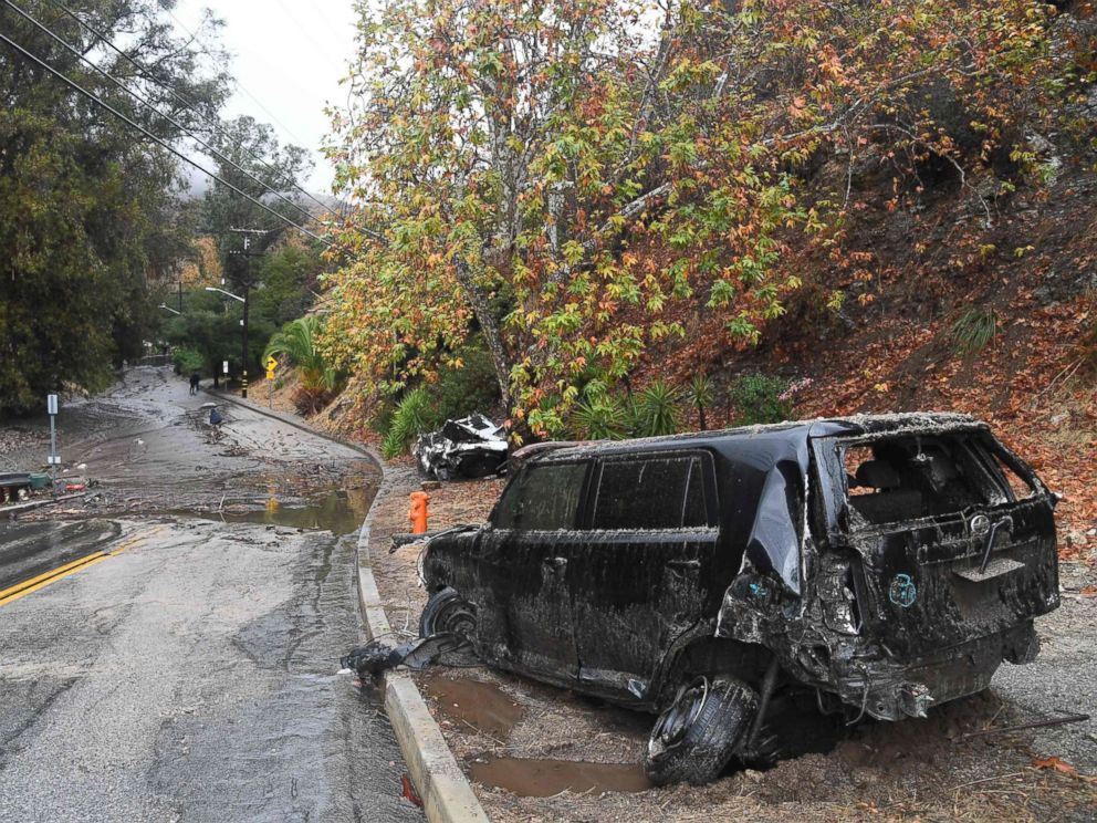 PHOTO: Two cars that were washed downhill in a rain-driven mudslide are seen in a neighborhood under mandatory evacuation in Burbank, Calif., Jan. 9, 2018.