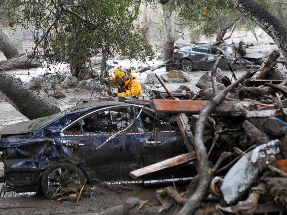 PHOTO: A member of the Long Beach Search and Rescue team looks for survivors in a car in Montecito, Calif., Jan. 9, 2018.
