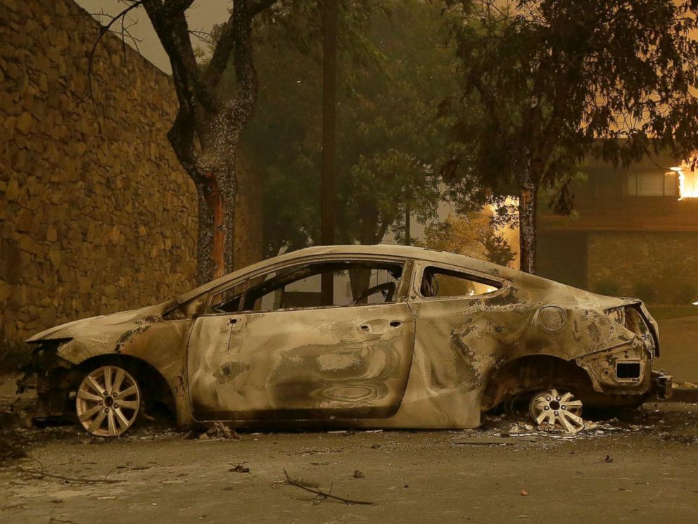 PHOTO: The remains of a car sits near the Fountaingrove Inn Hotel as it burns at rear in Santa Rosa, Calif., Oct. 9, 2017.