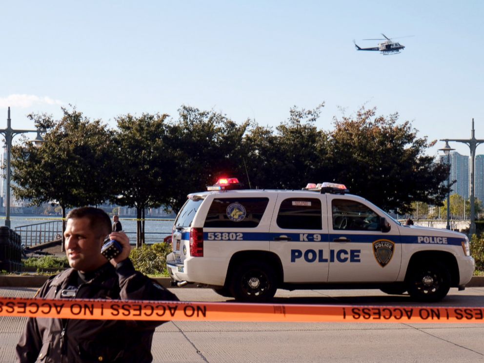 PHOTO: Police gather at the scene after reports of multiple people injured after a truck plowed through a bike path in lower Manhattan, Oct. 31, 2017, in New York City. 