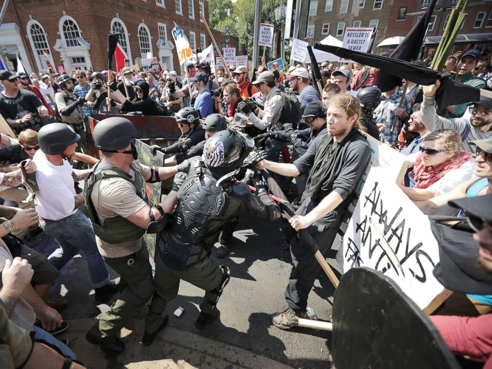 PHOTO: White nationalists, neo-Nazis and members of the alt-right clash with counter-protesters as they enter Lee Park during the Unite the Right rally, Aug. 12, 2017, in Charlottesville, Virginia.