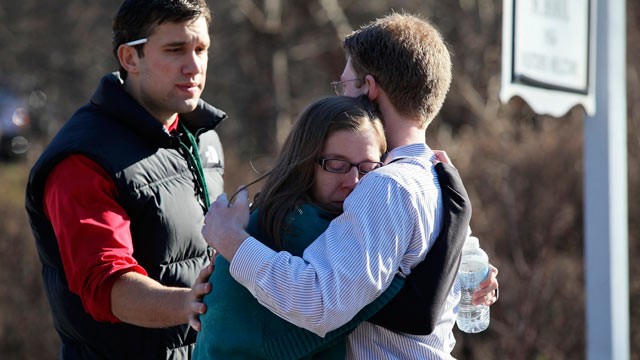 PHOTO: People console each other outside the Sandy Hook Elementary School following a shooting inside the school in Newtown, Conn., Dec. 14, 2012.