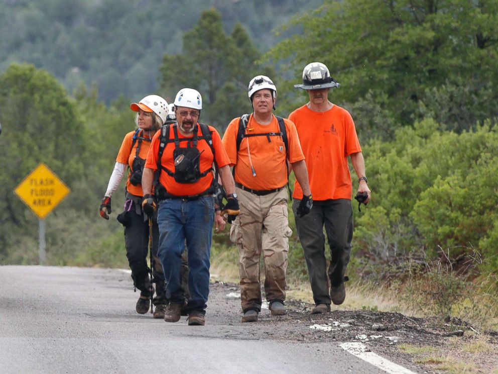 PHOTO: Members of the Tonto Rim Search and Rescue team walk back to the Gila County Sheriffs Office mobile command center after searching along the banks of the East Verde River, July 16, 2017, in Payson, Ariz.