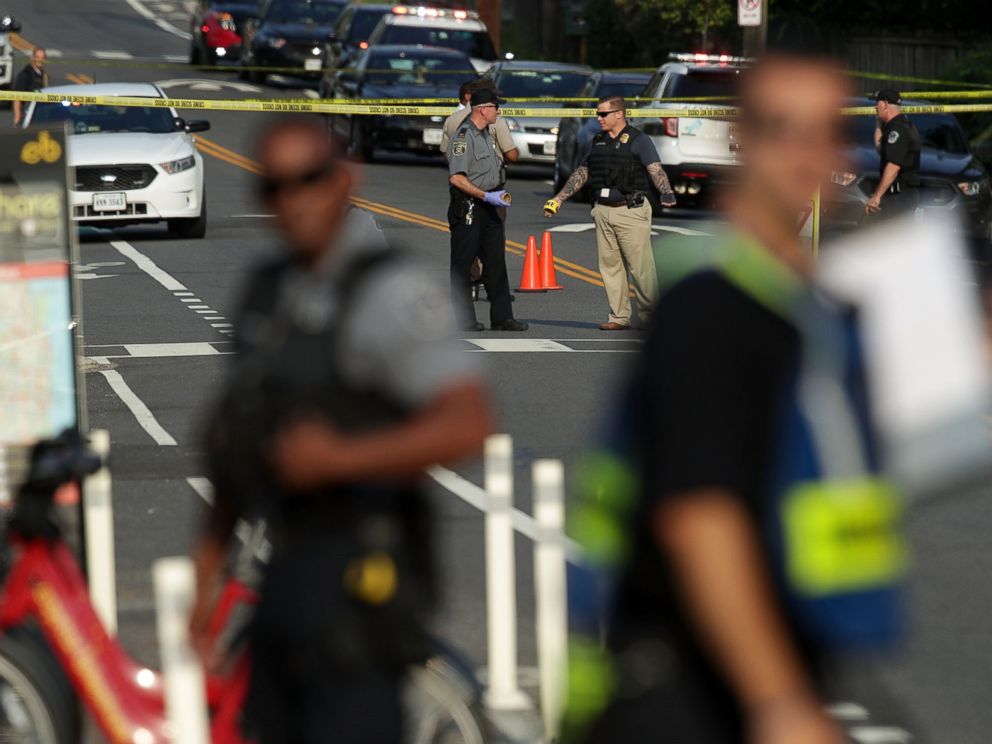 PHOTO: Investigators gather near the scene where fires were shot near where congressmen were gathered, June 14, 2017 in Alexandria, Va.