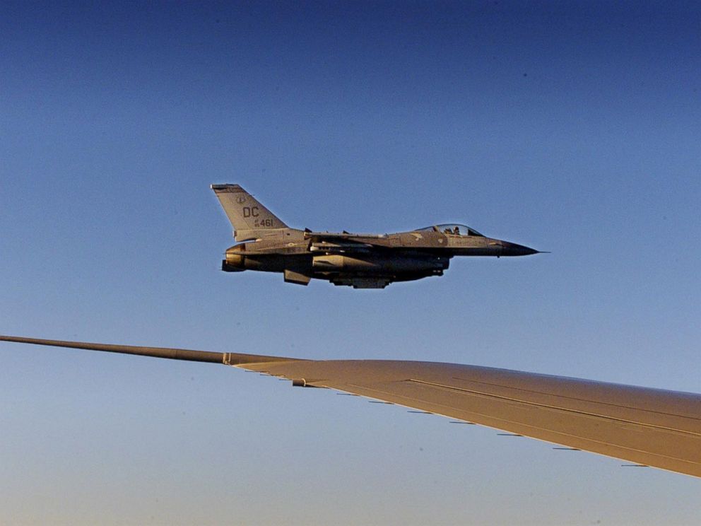 PHOTO: An F-16 fighter flies just off the wing of Air Force One on a flight back to Washington, Sept. 11, 2001.