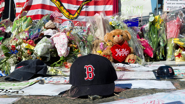 PHOTO: A Boston Red Sox cap left at a makeshift memorial on the Boston Marathon route, April 18, 2013, in Boston.