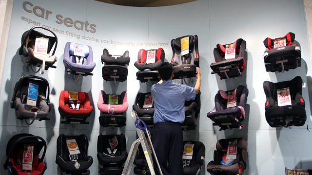 PHOTO: An employee removes a childs car seat from the display at a Mothercare Place store in London, May 12, 2011.