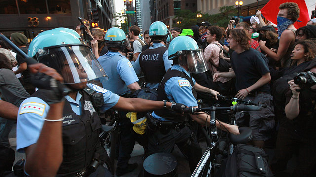 PHOTO: Demonstrators break through police lines as they march through the downtown streets on May 19, 2012 in Chicago, Illinois.