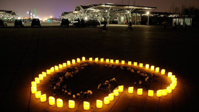 PHOTO: Chinese people light candles to mourn for the victims of the Boston Marathon explosion at Olympic Forest Park, April 16, 2013, in Beijing.