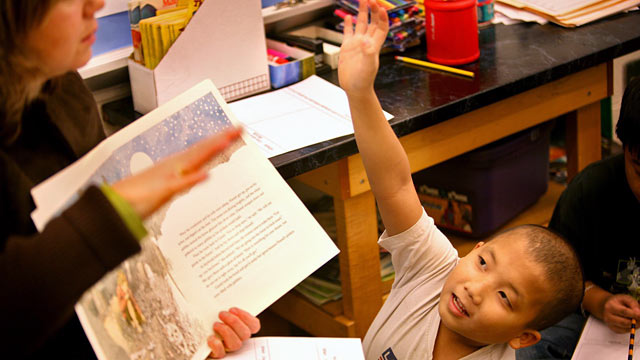 PHOTO: Third grade student Kao Xiong sits beside ELL teacher Concha Fernandez del Ray, during a reading lesson.