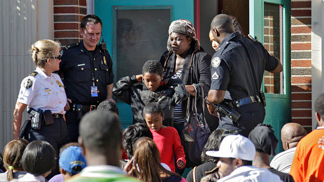 PHOTO: Anxious parents crowd the entrance to Brown Middle School where students were brought after being evacuated from Finch Elementary School in Atlanta, Dec. 3, 2012.