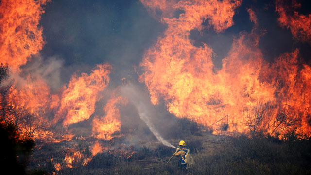 PHOTO: A Forestry fire fighter fights a wall of fire during an out of control wildfire, May 2, 2013 in Camarillo, Calif.