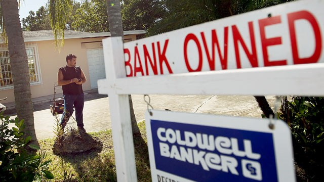 PHOTO: A man maintains the yard around a foreclosed home after the bank hired him to keep the home from falling into complete dilapidation in this Nov. 10, 2011 file photo in Miami, Florida.