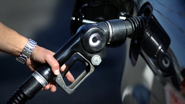 PHOTO: An attendant uses a fuel pump at a gas station in the Brooklyn borough of New York City on March 7, 2012.