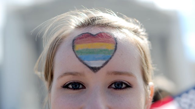 PHOTO: A same-sex marriage supporter has her forehead painted with rainbow colors as she joins demonstration in front of the Supreme Court, March 27, 2013, in Washington.