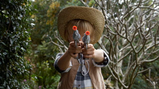 PHOTO: Boy a plays with toy gun.