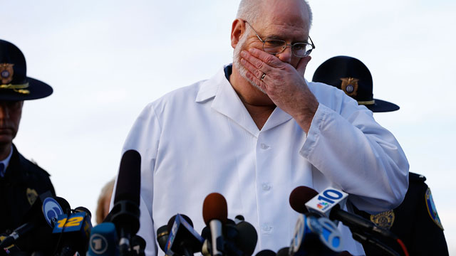PHOTO: Connecticut Chief Medical Examiner H. Wayne Carver II talks to the media and answers questions the media about the elementary school shooting during a press conference at Treadwell Memorial Park on December 15, 2012 in Newtown, Connecticut, a day a