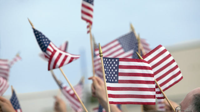 PHOTO: A crowd of people are seen waving flags at a Memorial Day Parade, in this undated photo.