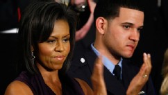 PHOTO: Michelle Obama applauds her husband, President Barack Obama, while he addresses a joint meeting of Congress as Philadelphia Police Officer Richard DeCoatsworth, right, stands by her, Feb. 24, 2009, at the U.S. Capitol in Washington, DC.