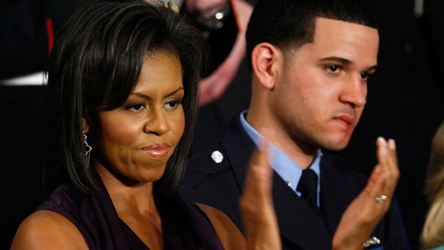 PHOTO: Michelle Obama applauds her husband, President Barack Obama, while he addresses a joint meeting of Congress as Philadelphia Police Officer Richard DeCoatsworth, right, stands by her, Feb. 24, 2009, at the U.S. Capitol in Washington, DC.