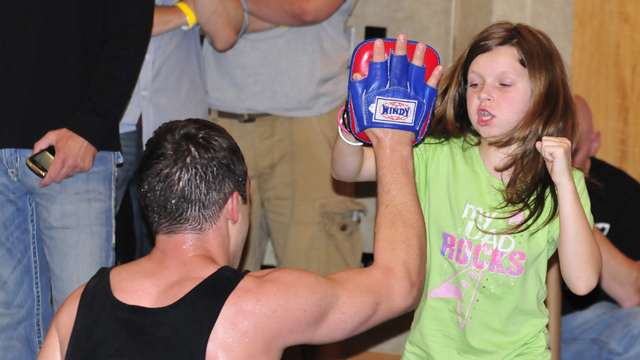 PHOTO: A young girl punches the hand of a MMA trainer during an open workout at the Hyatt Regency on June 24, 2011 in Pittsburgh, Penn.