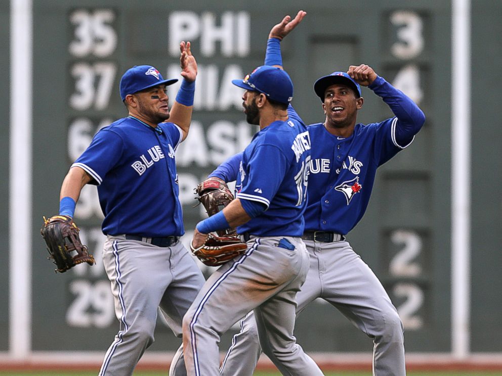 PHOTO:Melky Cabrera, Toronto, Jose Bautista, and Anthony Gose of the Toronto Blue Jays celebrate the 7-2 win with a dance in the outfield.
