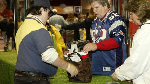 PHOTO: A New England Patriots fan entering the NFL experience goes through security screening at the Ernest N. Morial Convention Center in New Orleans, La.