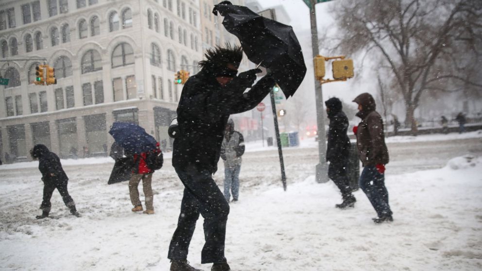 PHOTO: A man struggles with his umbrella while walking through the snow on Feb. 13, 2014 in New York City.