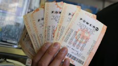 PHOTO: A customer holds $140 worth of Powerball tickets that he just purchased on May 17, 2013 in San Francisco, Calif.
