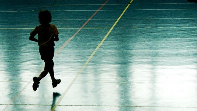 PHOTO: A young boy running on a basketball court.